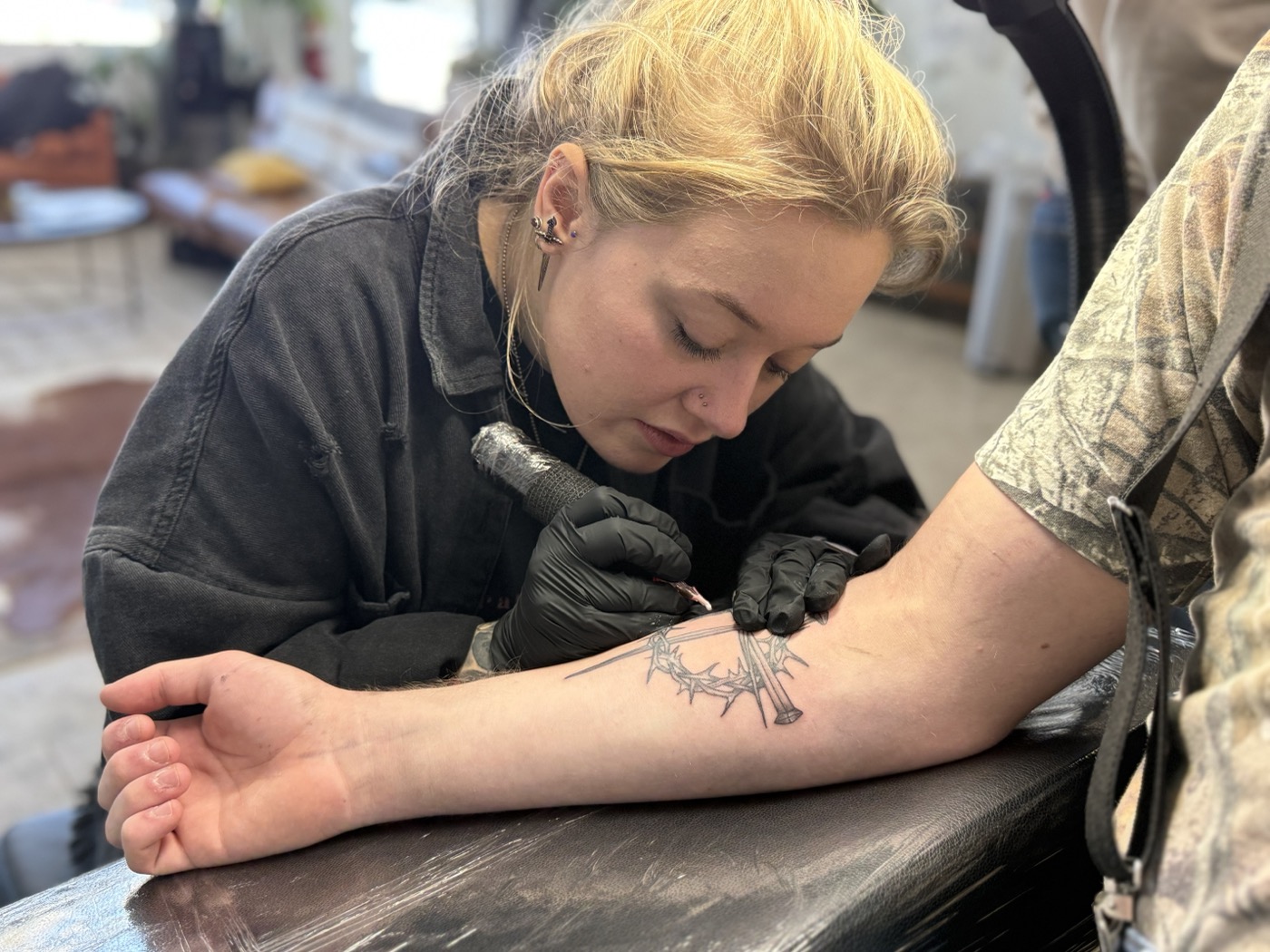 Cat Bernardy tattooing a client at Rabbit's Paw Tattoo