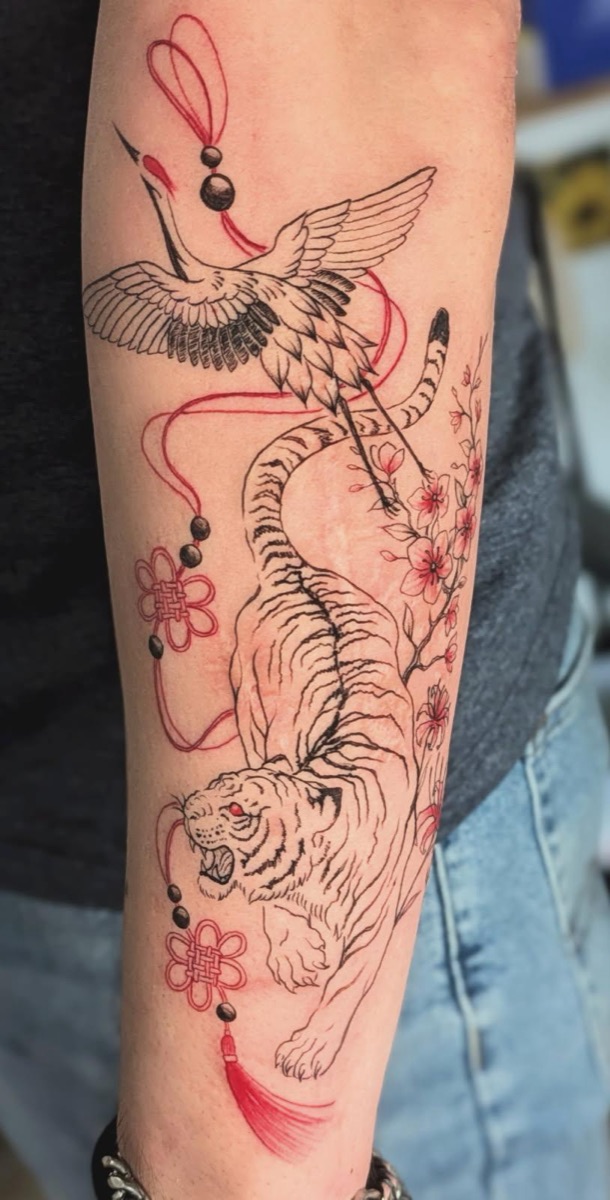 Tiger with crane and cherry blossoms in red and black fine line — tattoo by Melody